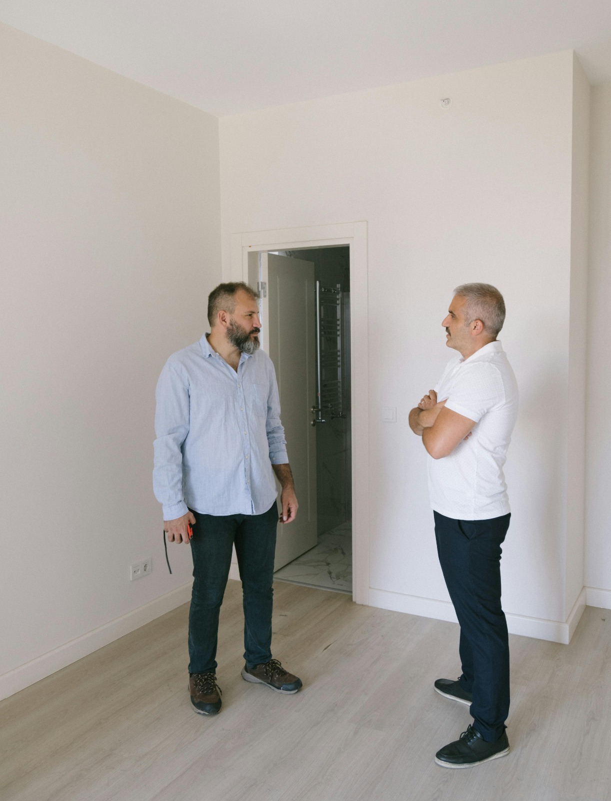 Home renovation adviser speaking with a homeowner inside a property